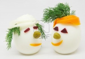 7072630-two-white-eggs-decorated-with-dill-onion-and-carrots-on-white-background